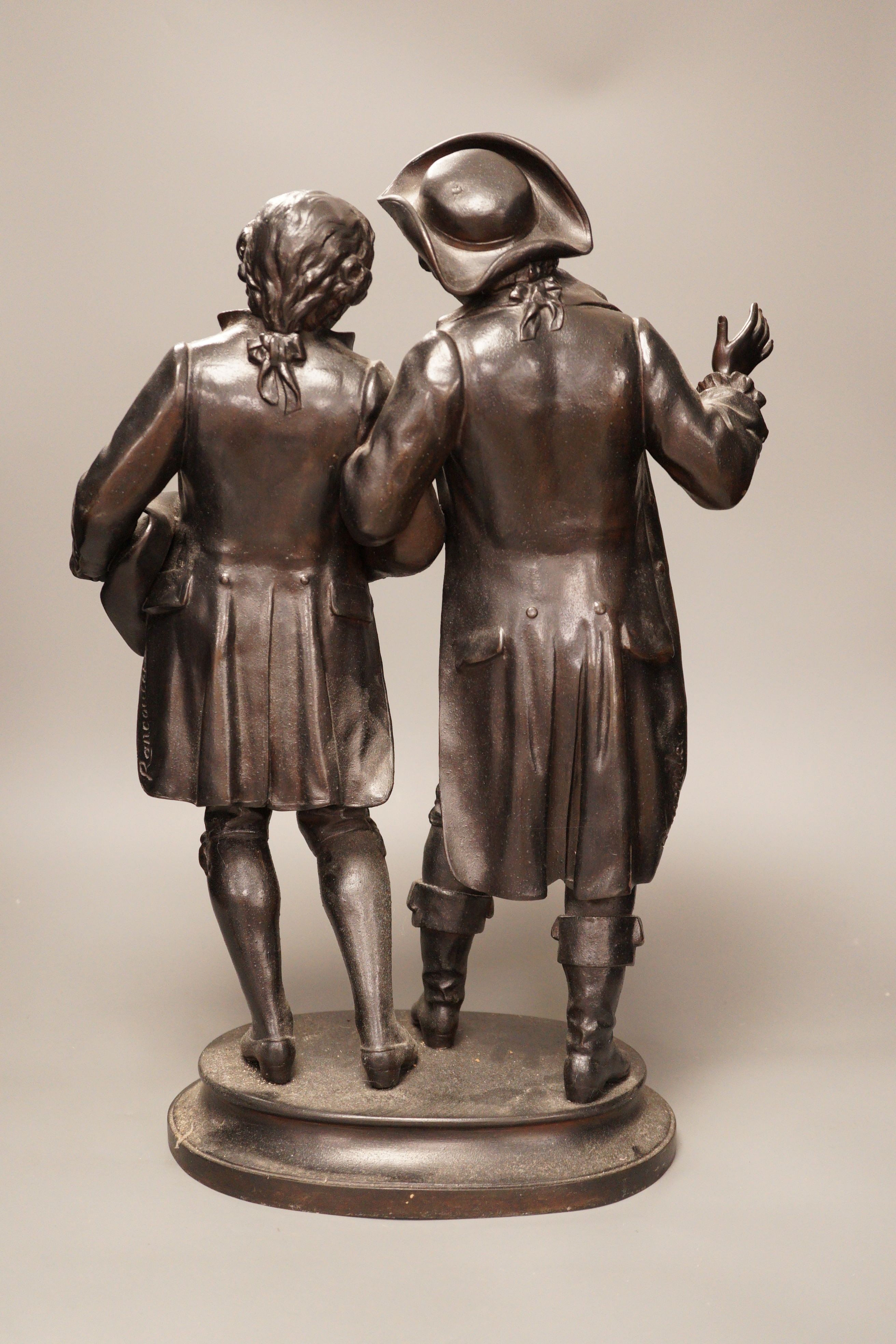 A black patinated spelter group, two 18th century figures in conversation, 48cm tall